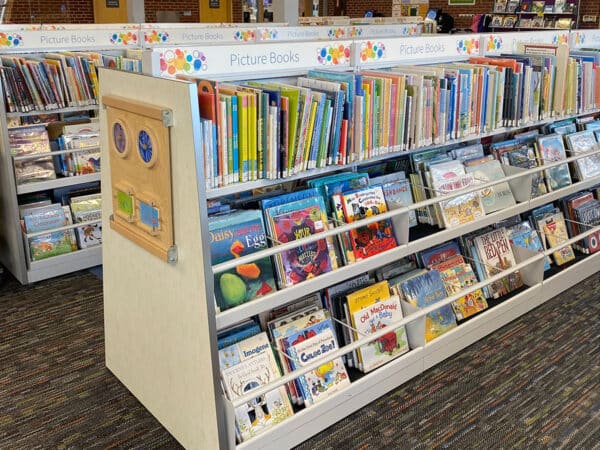 double-faced browse bins with spine-out top row and 2 face-out shelves with custom activity end panels