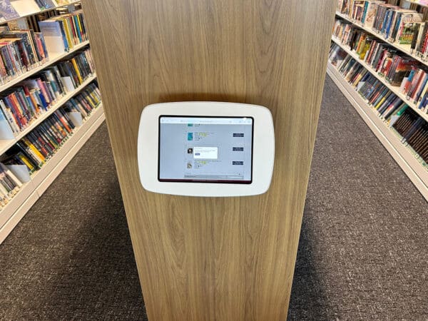 Wall-mounted OPAC station with secure tablet or iPad.
